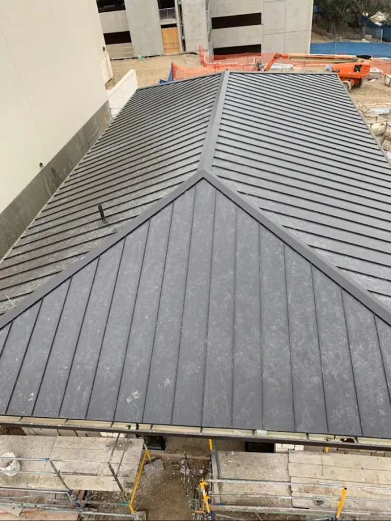 Commercial metal roof construction with crane equipment in Franconia